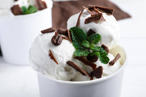 istock Yummy ice cream with chocolate in paper cup, closeup 1390810469