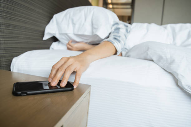 istock Woman snooze the alarm clock 1390811479