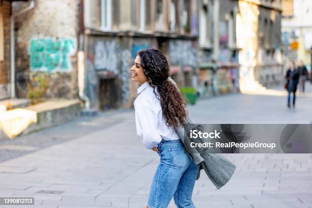Young Woman Walkingwoman Smiling While Walking Outdoors On The Street Stock Photo - Download Image Now