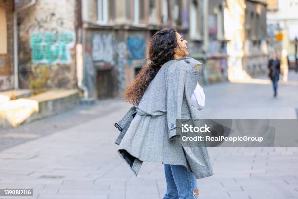 Young Woman Walkingwoman Smiling While Walking Outdoors On The Street Stock Photo - Download Image Now