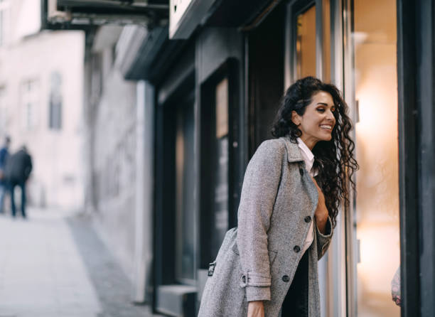 istock Beautiful young woman doing window shopping 1390812842