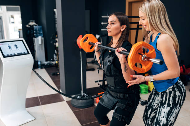istock A smiling fitness instructor enjoys helping her client lift weights 1390813025