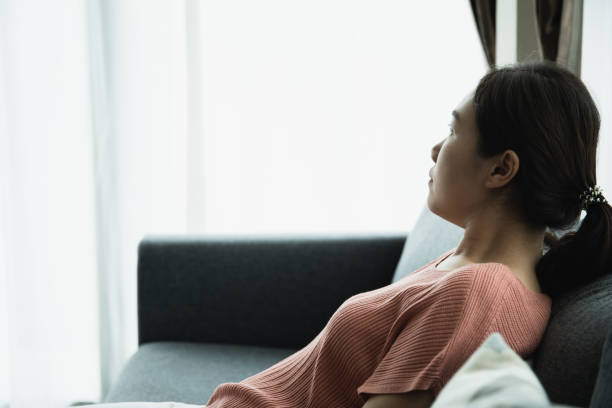 istock Woman relaxing and sitting on the sofa. 1390813120