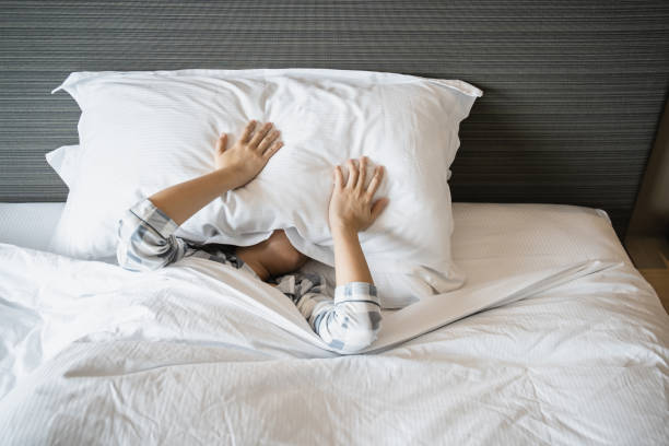 istock Lazy woman waking up from the bed. 1390813184