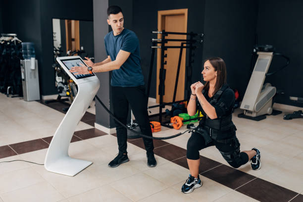 istock The woman does the step forward exercise while connected to the ems machine 1390814070
