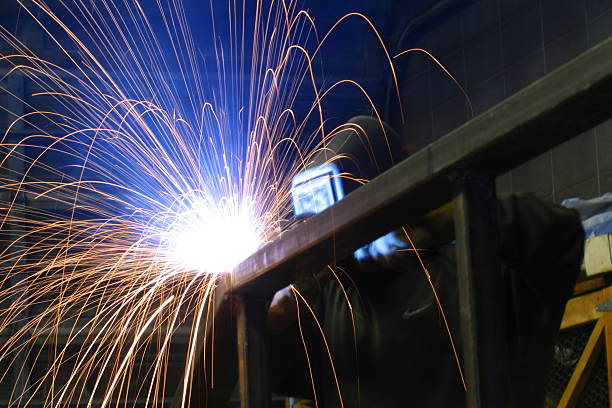 istock Welder welding steel bars while wearing mask 139081422