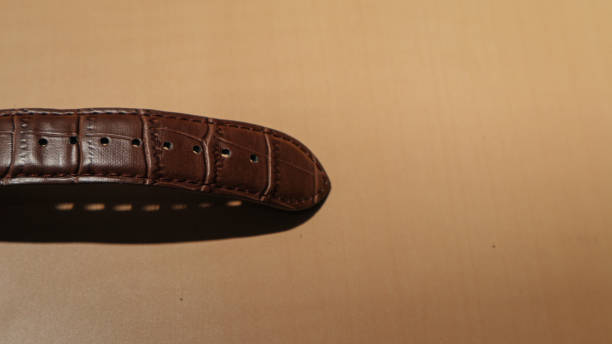 istock Brown leather watch strap on the office desk 1390814399
