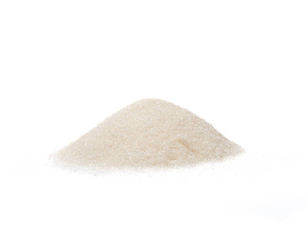 istock A pile of white sugar on a white background. 1390814714