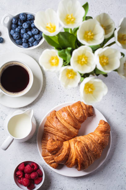 istock Delicious breakfast with croissants, coffee and berries, gray background. 1390816094