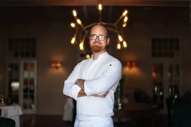 Photo of Portrait of the head chef at a gourmet restaurant.