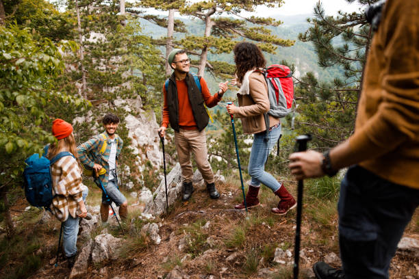 istock Happy backpackers talking on a rocky mountain. 1390817193