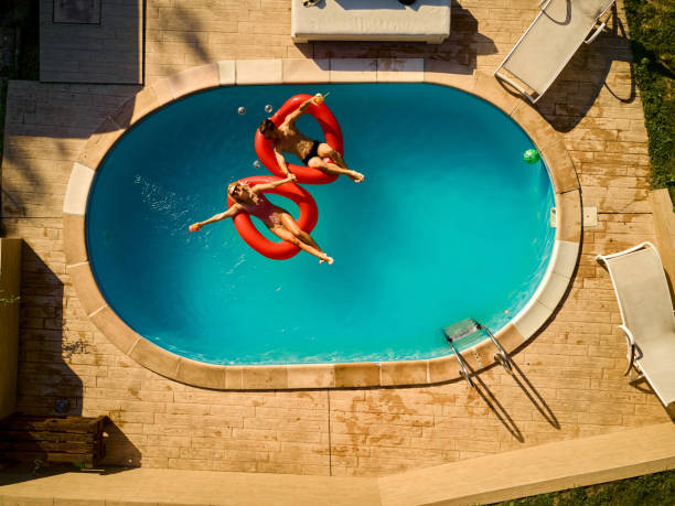 istock Couple relaxing in a swimming pool 1390818426