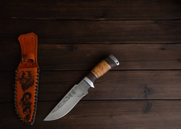 istock hunting knife on a wooden table 1390818545