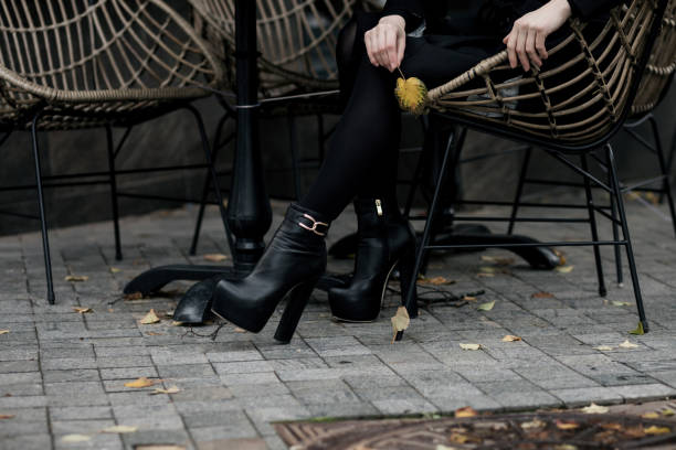 istock Legs in black pantyhose wearing boots 1390818856