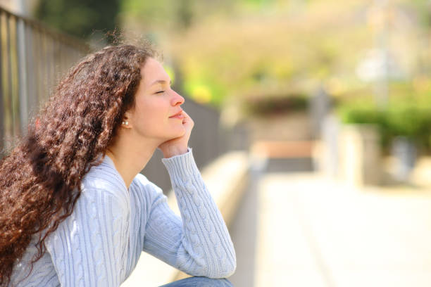 istock Woman relaxing a sunny day in a park 1390819532