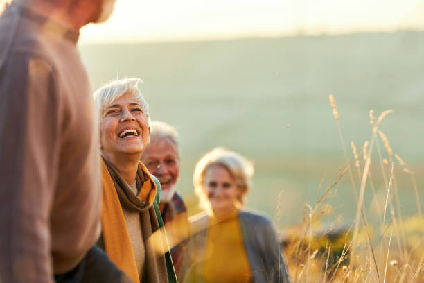 istock Happy senior friends talking in autumn day. 1390819595