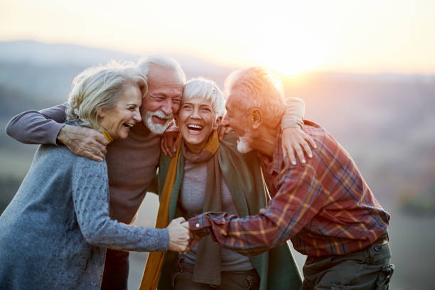 istock Happy embraced friends talking in nature at sunset. 1390819780