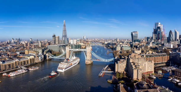 Panoramic aerial view of the skyline of London with the lifted Tower Bridge Panoramic aerial view of the skyline of London with the lifted Tower Bridge and a cruise ship passing under london stock pictures, royalty-free photos & images