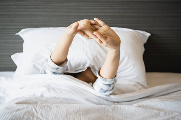 istock Lazy woman waking up from the bed. 1390820173