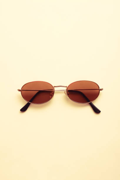 istock Brown sunglasses on bright cream white background. 1390820283