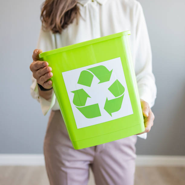 istock Young Asian woman with a crate for recycling. 1390821387