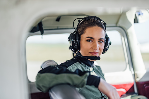 Focused adult woman, checking if all the passengers are in the plane.