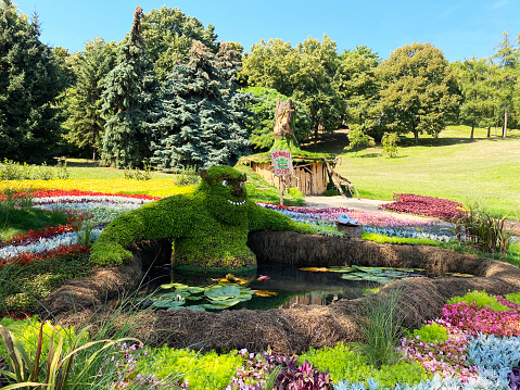 Funny figurines of cartoon characters made of colorful flowers in the park at the flower show