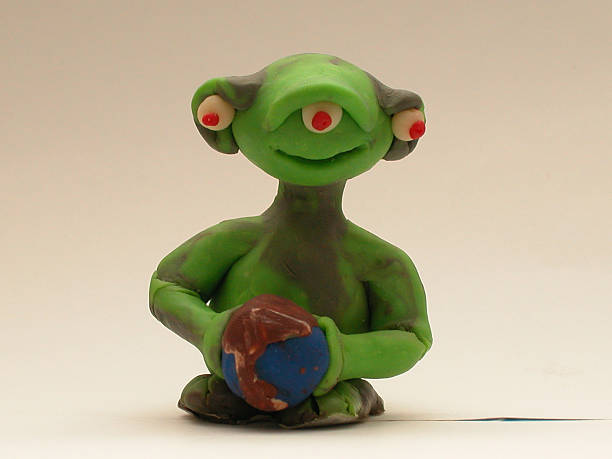 istock PLAY DOH - friendly Alien holding the earth 139082468