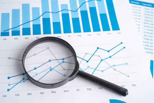 istock Magnifying glass on charts graphs paper. Financial development, Banking Account, Statistics, Investment Analytic research data economy, Stock exchange trading, Business office company meeting concept. 1390825719