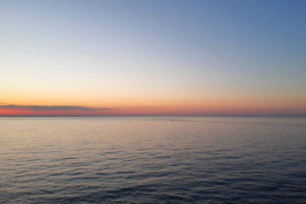 Beautiful sunrise that colors the sky orange and sea panorama in Diano Marina in Liguria, travels and landscapes in Italy