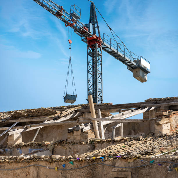 crane and damaged roof in a construction site - italy europe - roof tile architectural detail architecture and buildings built structure imagens e fotografias de stock