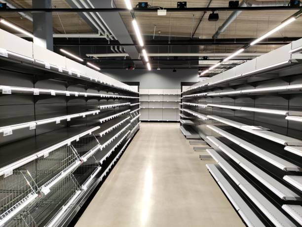 istock Empty shelves and racks in an empty, new supermarket. 1390827394