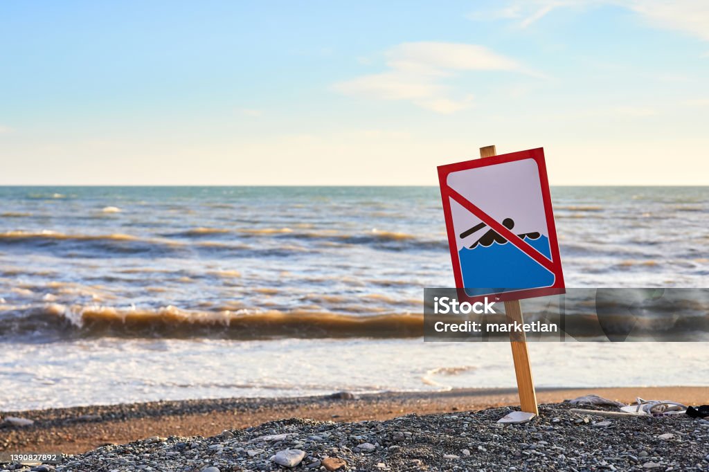 Warning no swimming sign with strong sea wave by the beach background Sea Stock Photo