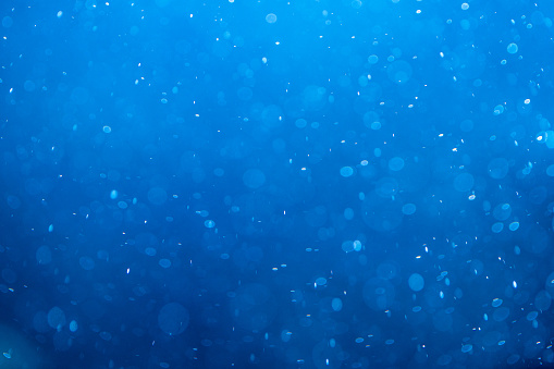 Abstract particles background in deep blue colors