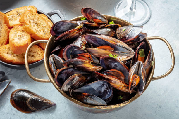 istock Cooked mussels in a copper pan, Belgian cuisine in a restaurant 1390828236