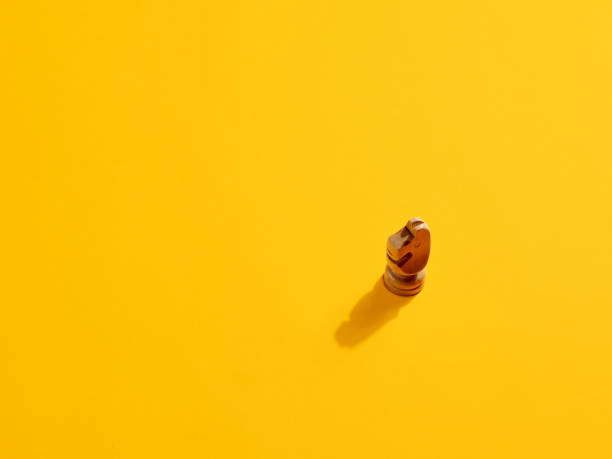 istock Knight or horse chess piece on yellow background 1390830608