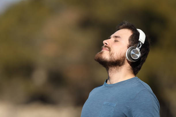 istock Man meditating with headphones in nature 1390831174