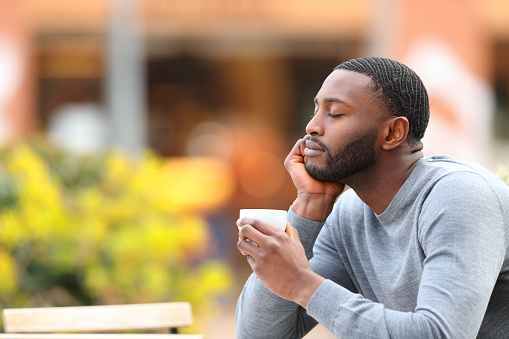 istock Man with black skin resting and relaxing drinking coffee 1390831851