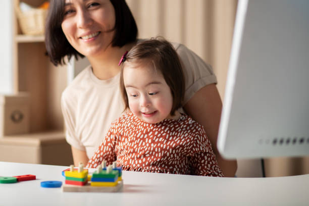 istock cute baby with down syndrome with mom 1390833386