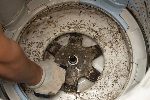 istock man taking apart a dirty washing machine 1390833913