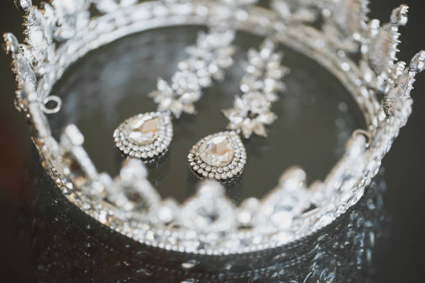 istock jewelry crown earrings on a glass table. 1390835208