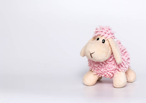 istock White-pink Lamb plush toy. Gray background. 1390835813