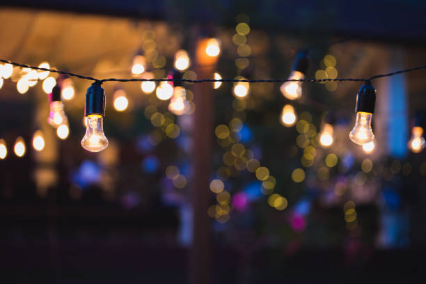 istock Light bulb decor in outdoor party. Wedding banquet. 1390835964