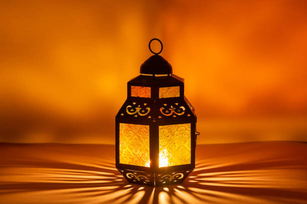 Traditional Arabic lantern lit up for celebrating the Holy Month of Ramadan Traditional Arabic lantern lit up for celebrating the Holy Month of Ramadan. High quality photo. eid lantern stock pictures, royalty-free photos & images