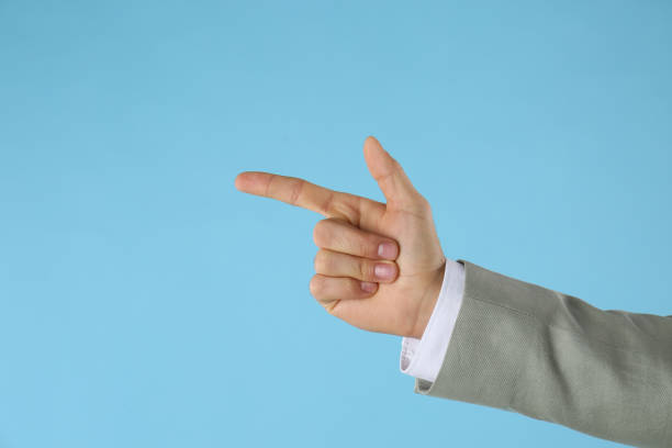 istock Businessman pointing at something on light blue background, closeup. Finger gesture 1390836224