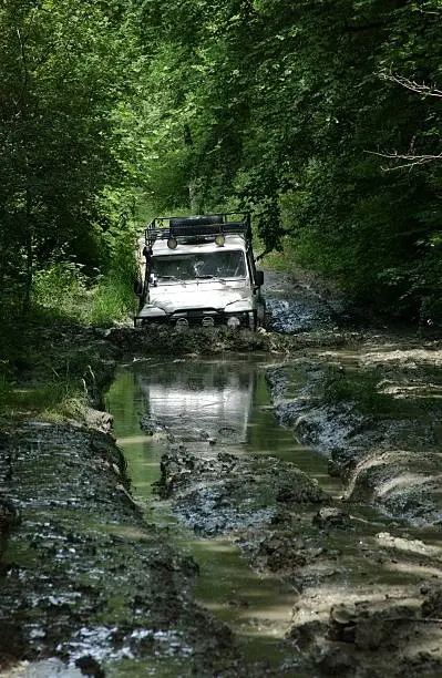 White landrover in crossing mud