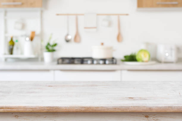istock Blurred kitchen background with wooden table top for in front 1390839242