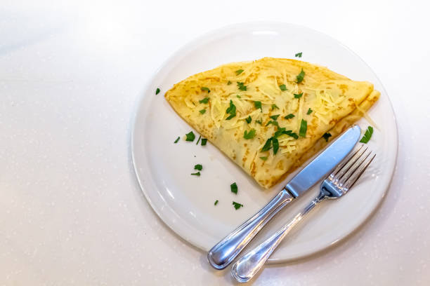 istock Russian pancakes with stuffing and sprinkled with grated cheese 1390839489
