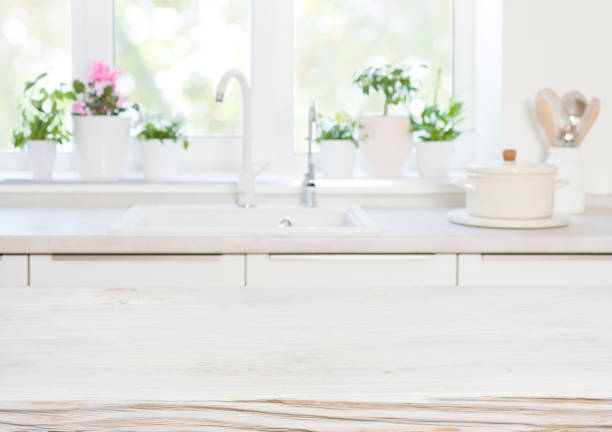 istock Wooden table on blurred background of kitchen blurred sink window 1390839846