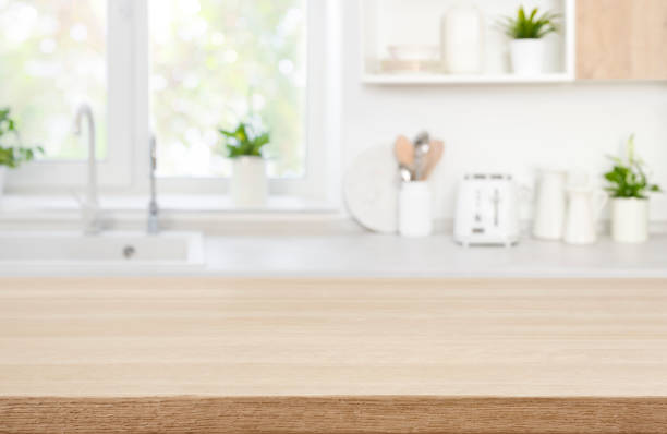Wood table top on blur modern kitchen room counter background stock photo